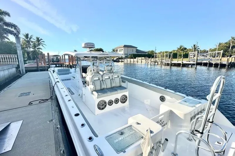 Slide: The Image of 2023 Twin Vee 340 GFX CC boat docked by a scenic waterfront. - 8