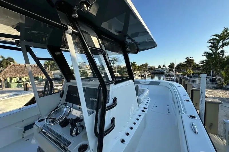 Slide: The Image of 2022 Invincible 35 Catamaran with modern helm, docked in a sunny marina. - 12