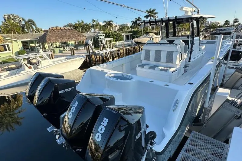 Slide: The Image of 2022 Invincible 35 Catamaran with triple Mercury engines docked at marina. - 14