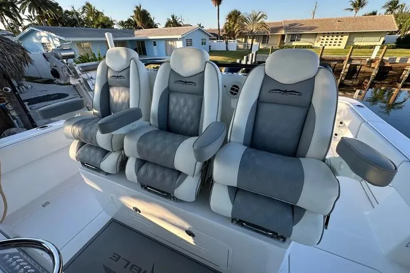 Slide: The Image of 2022 Invincible 35 Catamaran luxury seating with gray and white upholstery. - 17