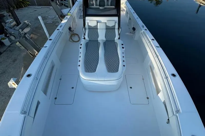 Slide: The Image of 2022 Invincible 35 Catamaran with spacious deck and comfortable seating, docked by calm water. - 19