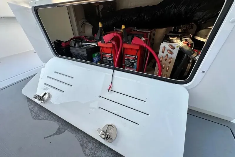Slide: The Image of Battery compartment of 2022 Invincible 35 Catamaran with visible wiring and components. - 26