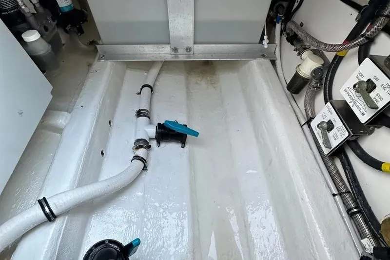Slide: The Image of Bilge area of 2022 Invincible 35 Catamaran with visible plumbing and wiring. - 29