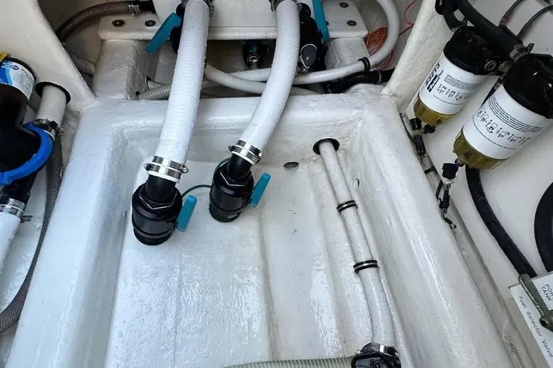Slide: The Image of Engine compartment of 2022 Invincible 35 Catamaran with hoses and filters visible. - 30