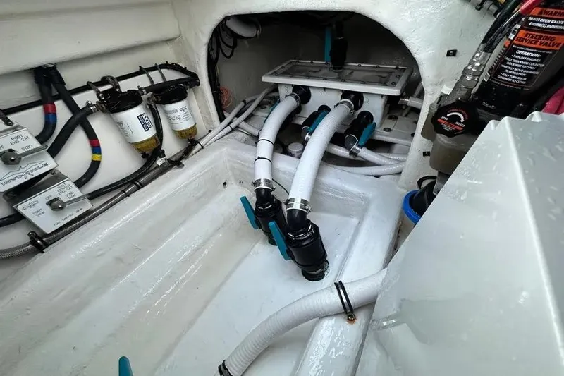 Slide: The Image of Engine compartment of 2022 Invincible 35 Catamaran with hoses and filters visible. - 33