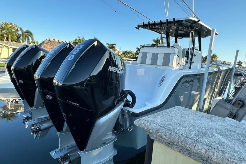 Slide: The Image of 2022 Invincible 35 Catamaran with triple Mercury outboard engines docked in a marina. - 39