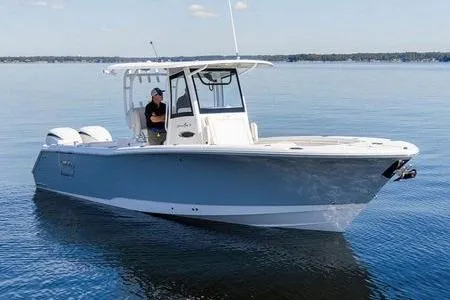 The Image of 2024 Sea Hunt Gamefish 28 boat on calm water, featuring sleek design and dual engines. - 0
