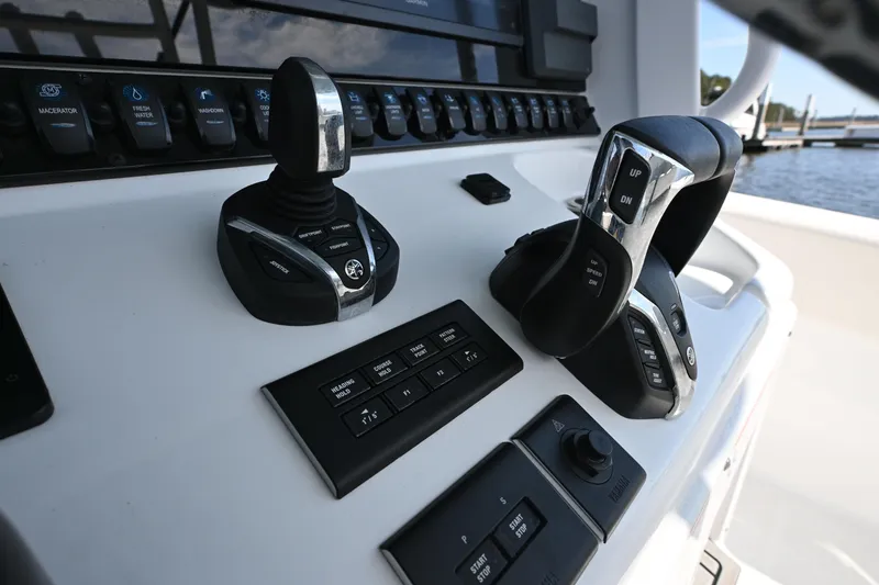 Slide: The Image of 2024 Sea Hunt Gamefish 28 control panel with joystick and throttle levers. - 10