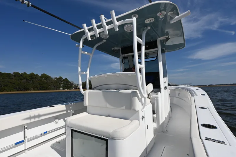 Slide: The Image of 2024 Sea Hunt Gamefish 28 boat on water, featuring spacious deck and seating. - 13