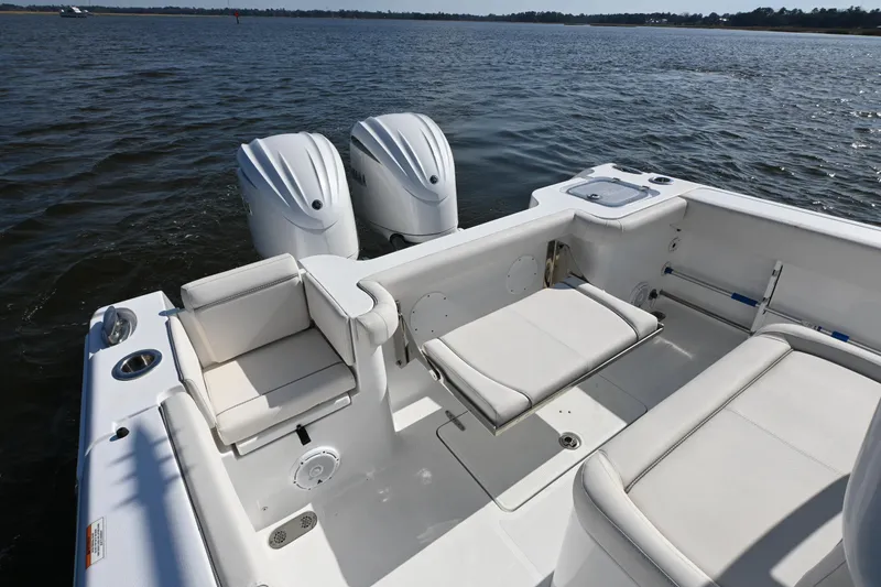 Slide: The Image of 2024 Sea Hunt Gamefish 28 boat interior with dual engines on calm water. - 17