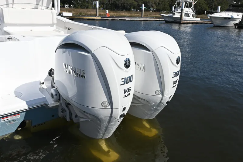Slide: The Image of 2024 Sea Hunt Gamefish 28 with dual Yamaha 300 V6 outboard engines at marina. - 19