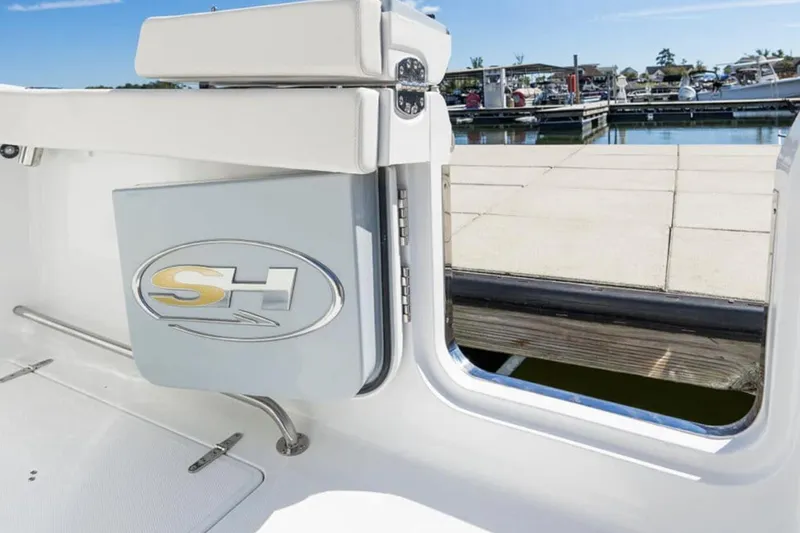 Slide: The Image of 2024 Sea Hunt Gamefish 28 boat with dual Yamaha engines on open water. - 2