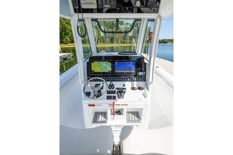 Slide: The Image of 2024 Sea Hunt Gamefish 28 boat cruising on open water with dual Yamaha engines. - 4