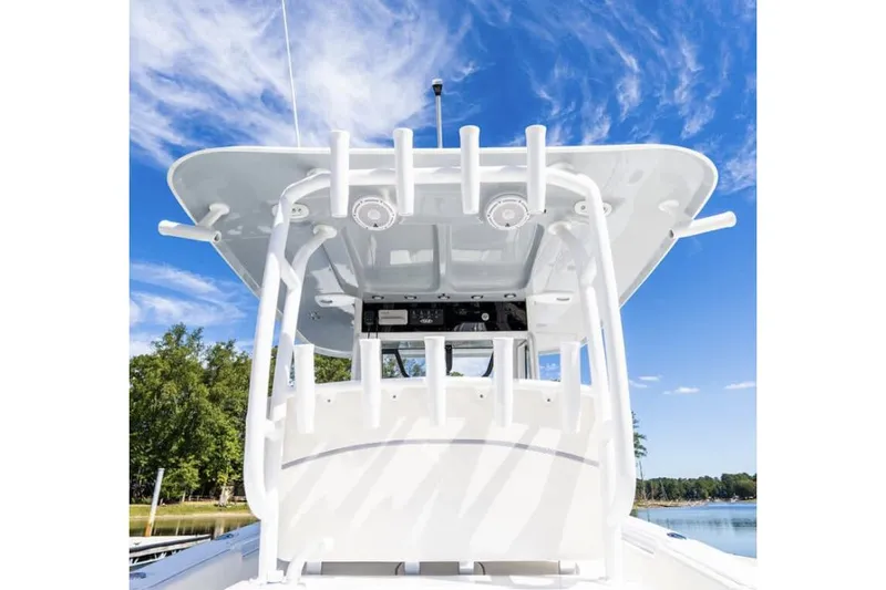 Slide: The Image of 2024 Sea Hunt Gamefish 28 boat on calm water, showcasing spacious deck and seating. - 5