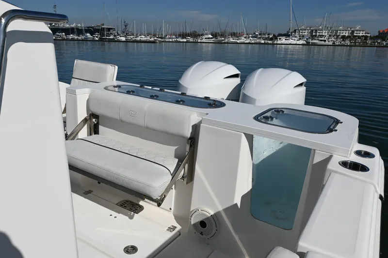 Slide: The Image of 2020 Sea Fox 288 Commander boat interior with seating and dual engines in marina. - 15