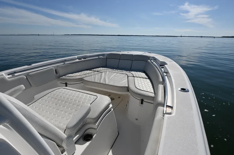 Slide: The Image of 2020 Sea Fox 288 Commander boat interior with cushioned seating on calm water. - 17