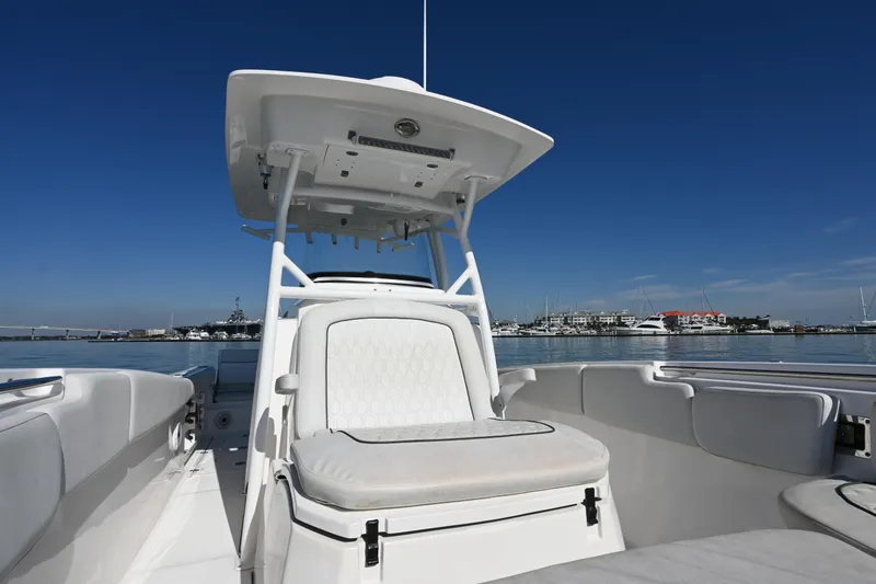 Slide: The Image of 2020 Sea Fox 288 Commander boat interior with seating, under clear blue sky. - 18