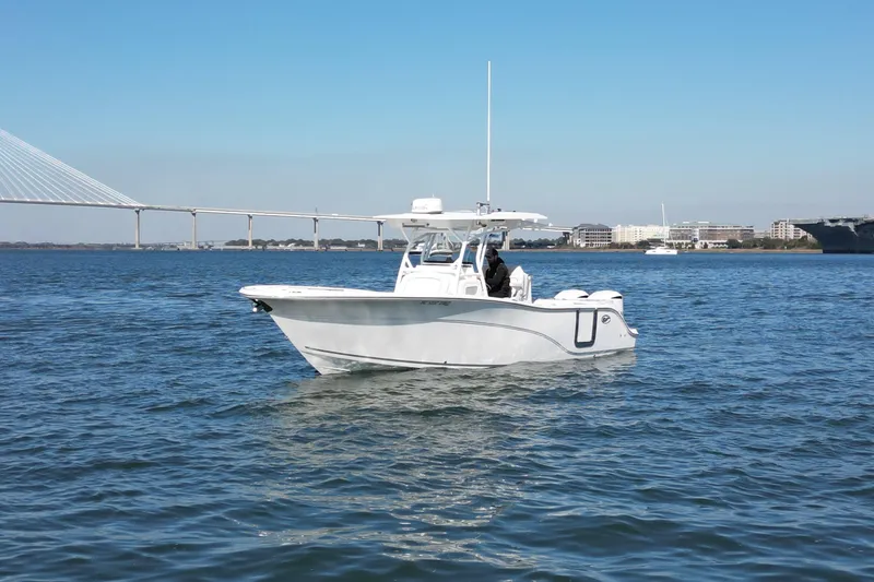 Slide: The Image of 2020 Sea Fox 288 Commander boat on water with bridge and cityscape background. - 3