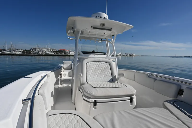 Slide: The Image of 2020 Sea Fox 288 Commander boat interior with white seating, docked at marina. - 4