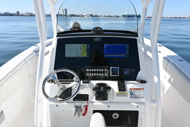 Slide: The Image of 2020 Sea Fox 288 Commander boat dashboard with navigation screens and steering wheel. - 8