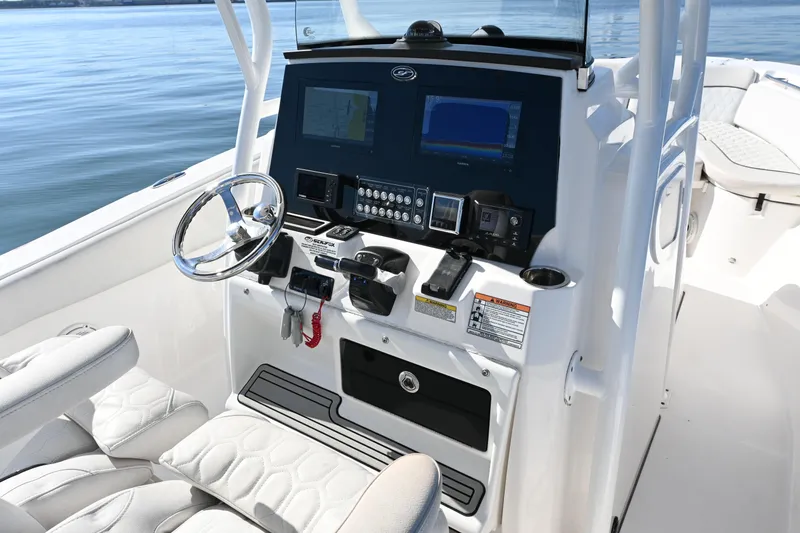 Slide: The Image of 2020 Sea Fox 288 Commander boat dashboard with steering wheel and navigation controls. - 9