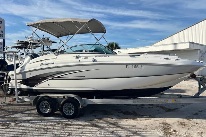 The Image of 2017 Hurricane SunDeck 2200 DC OB boat on trailer, parked outdoors. - 0