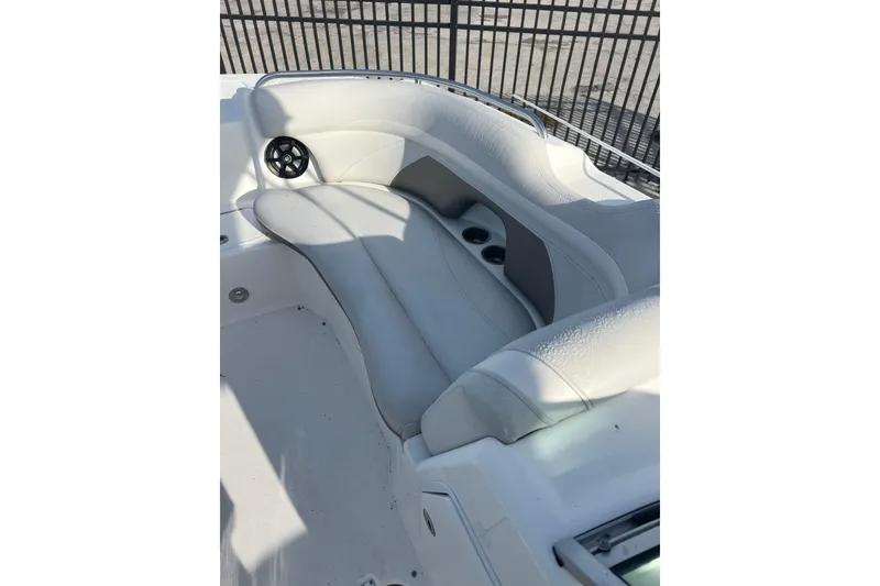 Slide: The Image of 2017 Hurricane SunDeck 2200 DC OB boat interior seating with cup holders and speaker. - 10