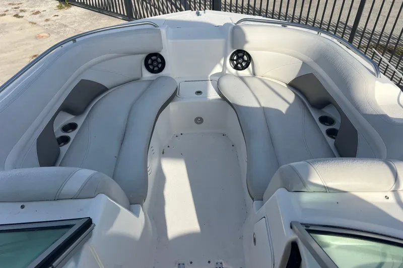 Slide: The Image of 2017 Hurricane SunDeck 2200 DC OB boat interior with white seating and cup holders. - 11