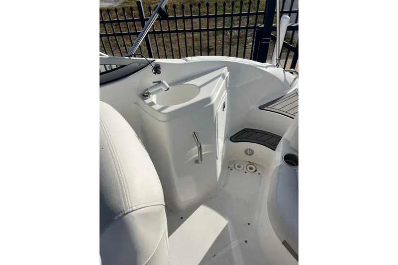 Slide: The Image of 2017 Hurricane SunDeck 2200 DC OB boat interior with sink and seating area. - 13