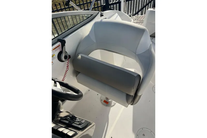 Slide: The Image of 2017 Hurricane SunDeck 2200 DC OB boat interior with steering wheel and seat. - 6