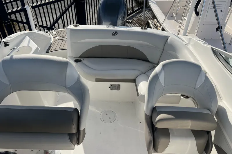 Slide: The Image of 2017 Hurricane SunDeck 2200 DC OB boat interior with seating and cup holders. - 8