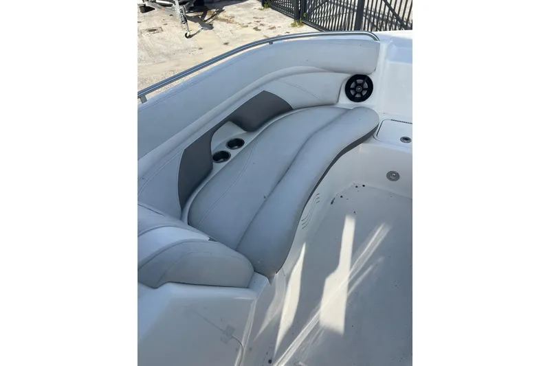Slide: The Image of 2017 Hurricane SunDeck 2200 DC OB boat interior with cushioned seating and cup holders. - 9