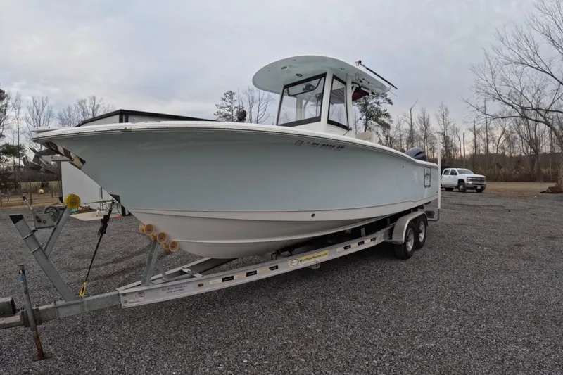 Slide: The Image of 2019 Sea Hunt Gamefish 25 boat on trailer, parked outdoors. - 14