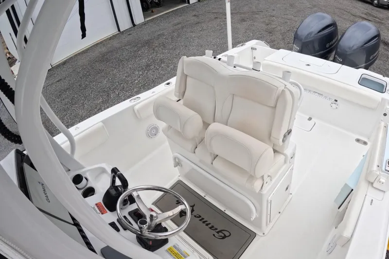 Slide: The Image of 2019 Sea Hunt Gamefish 25 boat interior with dual seats and steering wheel. - 3