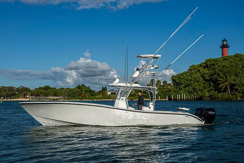 The Image of 2002 Yellowfin 36 Offshore boat cruising on a sunny day near a lighthouse. - 0