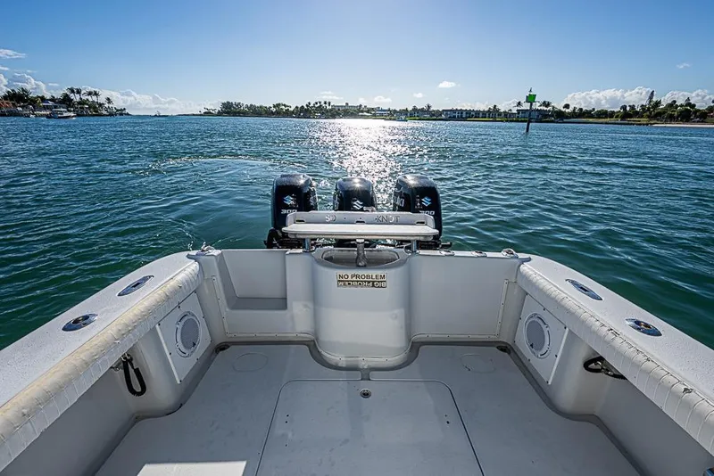 Slide: The Image of 2002 Yellowfin 36 Offshore boat with triple engines on a sunny day. - 10