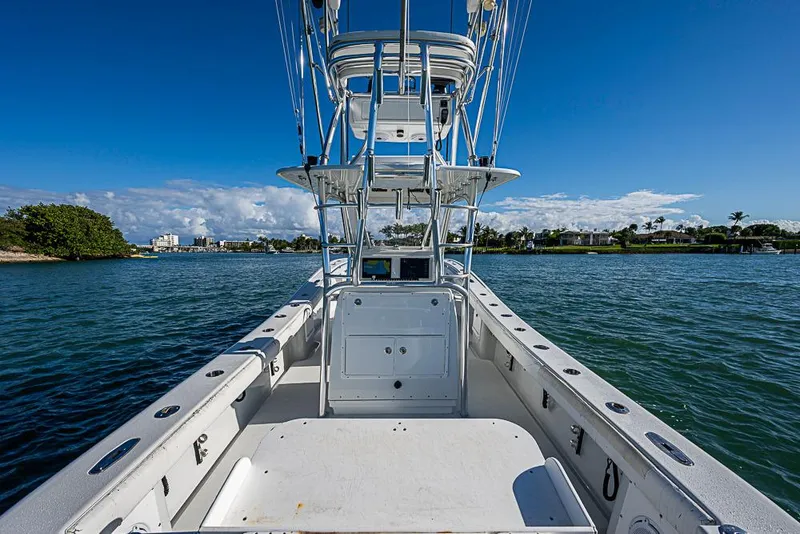 Slide: The Image of 2002 Yellowfin 36 Offshore boat on calm water under clear blue sky. - 13