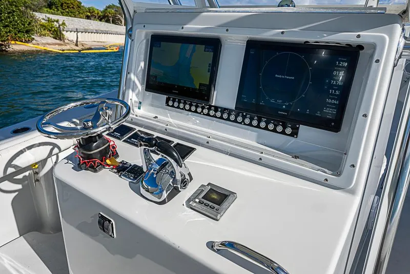 Slide: The Image of Control panel of a 2002 Yellowfin 36 Offshore boat with navigation screens. - 17