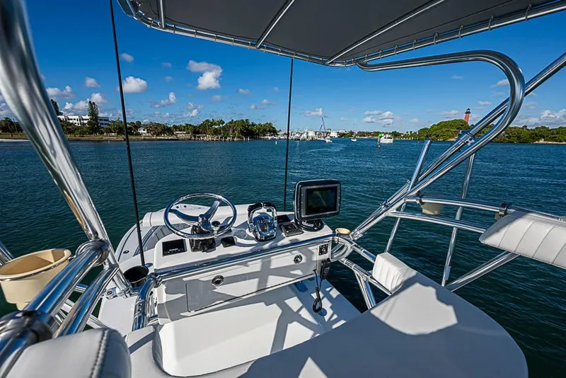 Slide: The Image of 2002 Yellowfin 36 Offshore boat helm with ocean view and clear blue sky. - 24