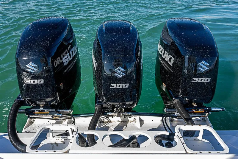 Slide: The Image of Triple Suzuki 300 outboard engines on a 2002 Yellowfin 36 Offshore boat. - 26