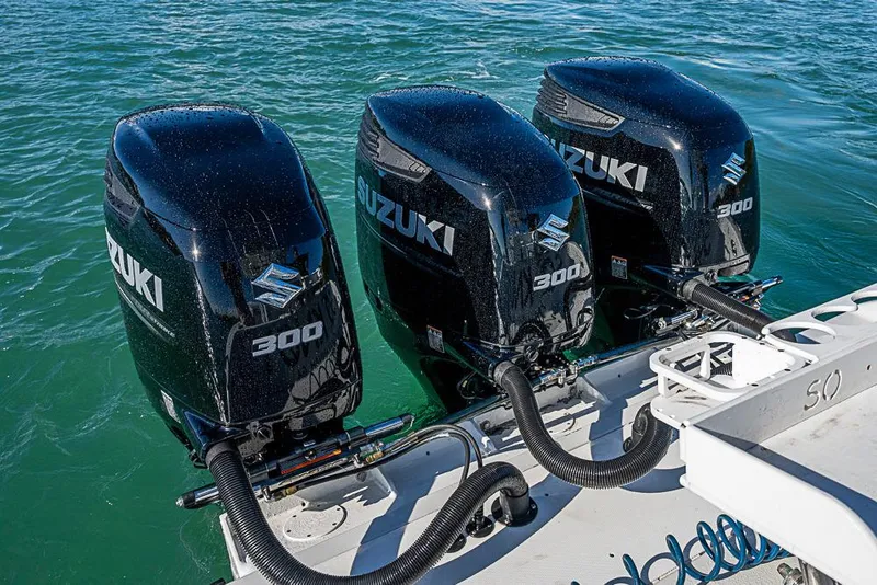 Slide: The Image of Triple Suzuki 300 outboard engines on a 2002 Yellowfin 36 Offshore boat. - 27