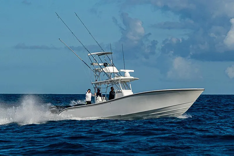 Slide: The Image of 2002 Yellowfin 36 Offshore boat cruising on open ocean under blue sky. - 28