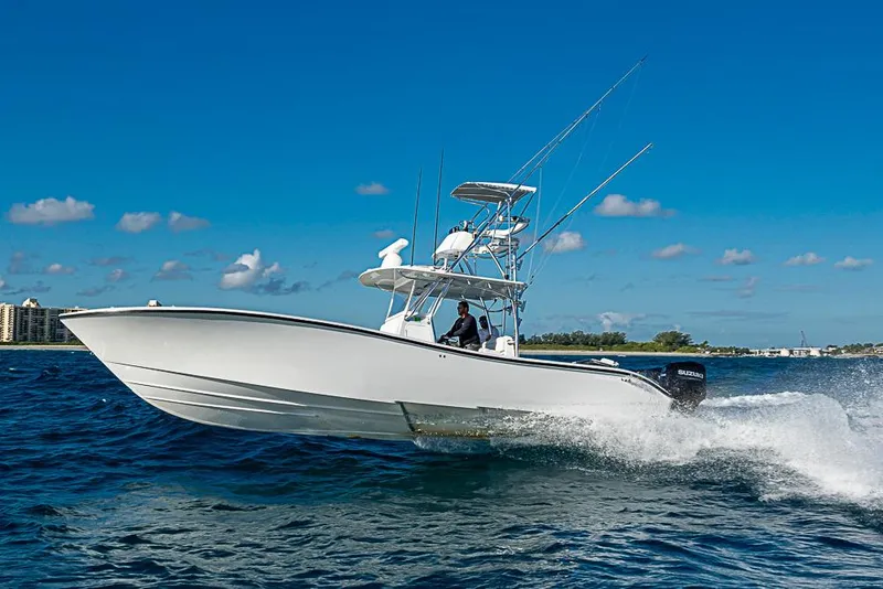 Slide: The Image of 2002 Yellowfin 36 Offshore boat cruising on open water under clear blue sky. - 29