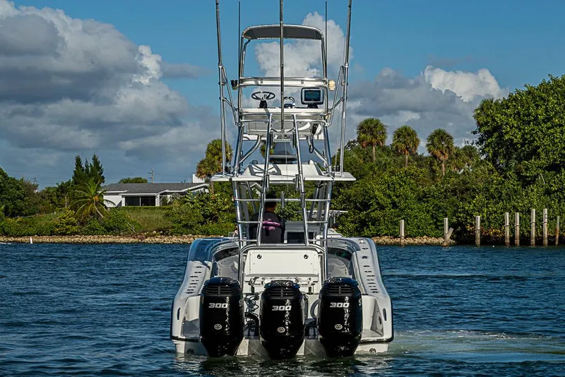 Slide: The Image of 2002 Yellowfin 36 Offshore boat with triple 300 horsepower engines on a sunny day. - 3