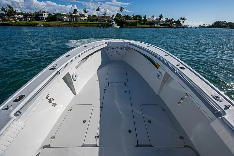 Slide: The Image of 2002 Yellowfin 36 Offshore boat on calm water, clear sky, and coastal view. - 4