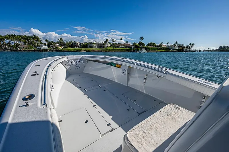 Slide: The Image of 2002 Yellowfin 36 Offshore boat on calm water, clear sky, coastal view. - 7