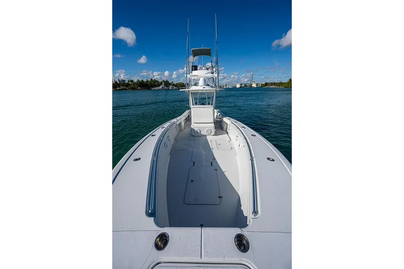 Slide: The Image of 2002 Yellowfin 36 Offshore boat on calm water under clear blue sky. - 8