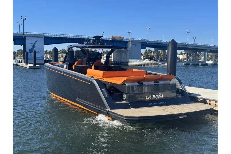 The Image of 2023 Pardo Yachts 50 cruising on clear blue water, featuring sleek design and orange seating. - 0