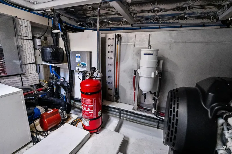 Slide: The Image of Engine room of 2023 Pardo Yachts 50, featuring equipment and fire extinguisher. - 50