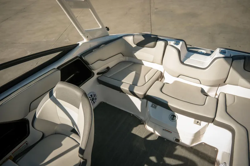 Slide: The Image of 2024 Yamaha Boats AR190 interior with beige seating and modern design. - 7